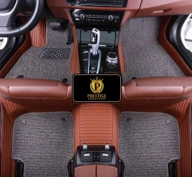 Ascot Pewter custom car floor mats with grey coil carpet set into a tan ribbed leather base, fitted across the front and rear footwells