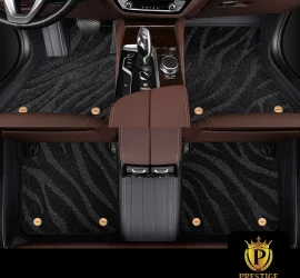 Onyx Black custom car floor mats in black shimmering wave-textured carpet with a black leather surround and gold badge studs
