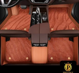 Onyx Caramel custom car floor mats in burnt-caramel wave-textured carpet with a tan leather surround, fitted front and rear