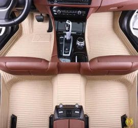 Portofino Beige custom car floor mats in cream ribbed leather with tonal stitching, fitted across the front and rear footwells of a car