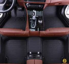 Portofino Black custom car floor mats in black ribbed leather with tonal stitching, fitted front and rear in a car with a tan interior