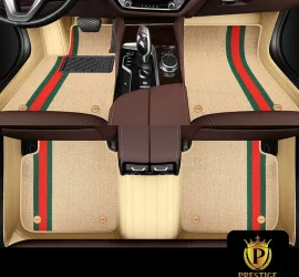 Riviera Champagne custom car floor mats in cream carpet with a red and green racing stripe, fitted across the front and rear footwells of a car