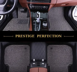 Sovereign Ash custom car floor mats in grey coil carpet with black leather edging, fitted across the front and rear footwells of a car