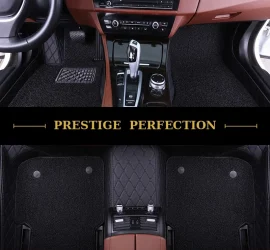 Sovereign Raven custom car floor mats in all-black coil carpet with black leather edging and black stitching, fitted front and rear