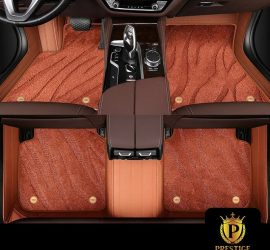 Onyx Caramel custom car floor mats in burnt-caramel wave-textured carpet with a tan leather surround, fitted front and rear